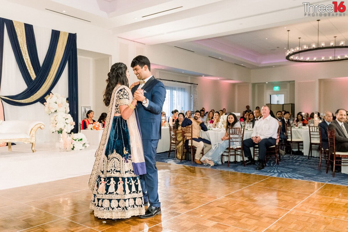 Bride and Groom gaze into each other's eyes as they slow dance their first dance together