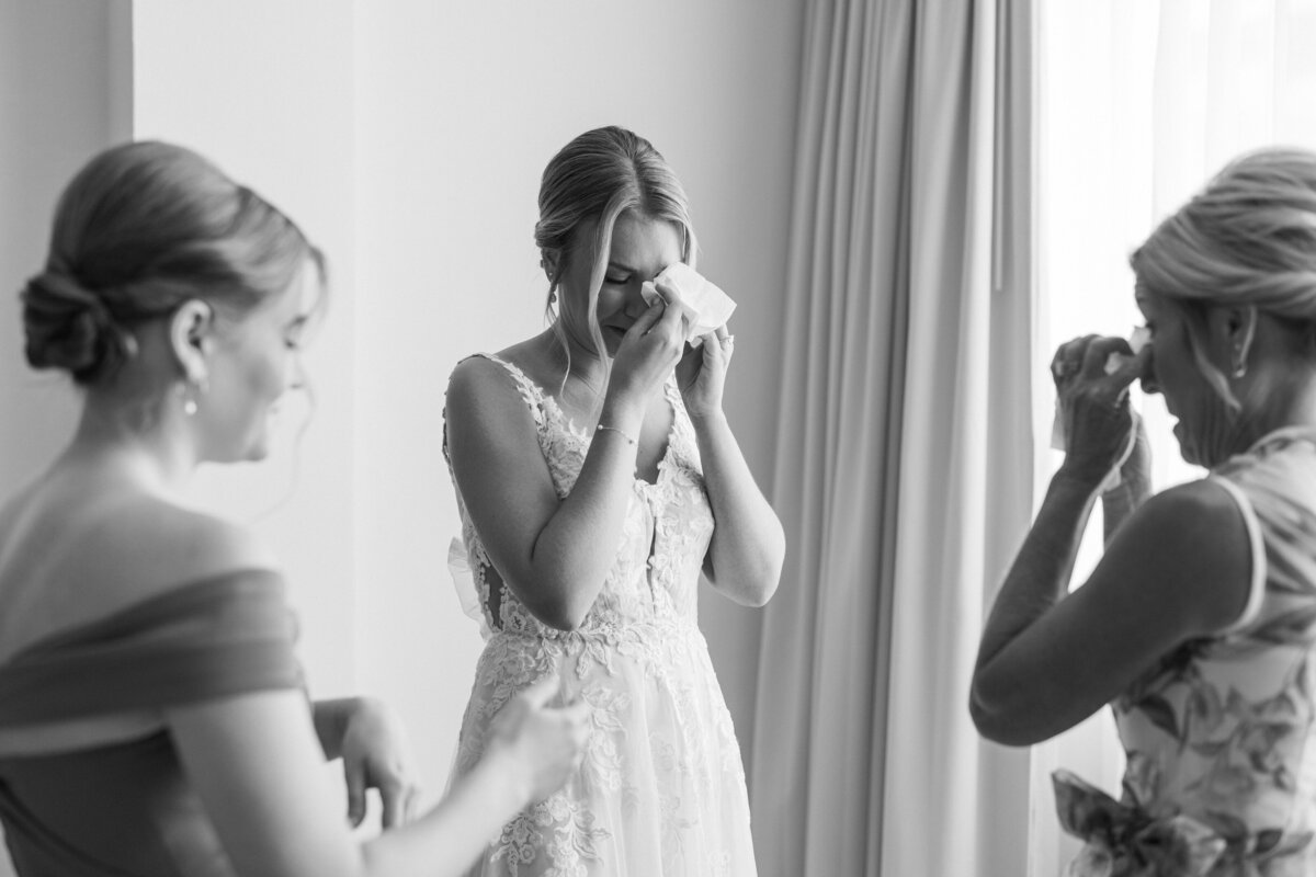 Bride and family tear up during emotional pre-wedding moment in Cancun, Mexico, captured by Philly photographer.