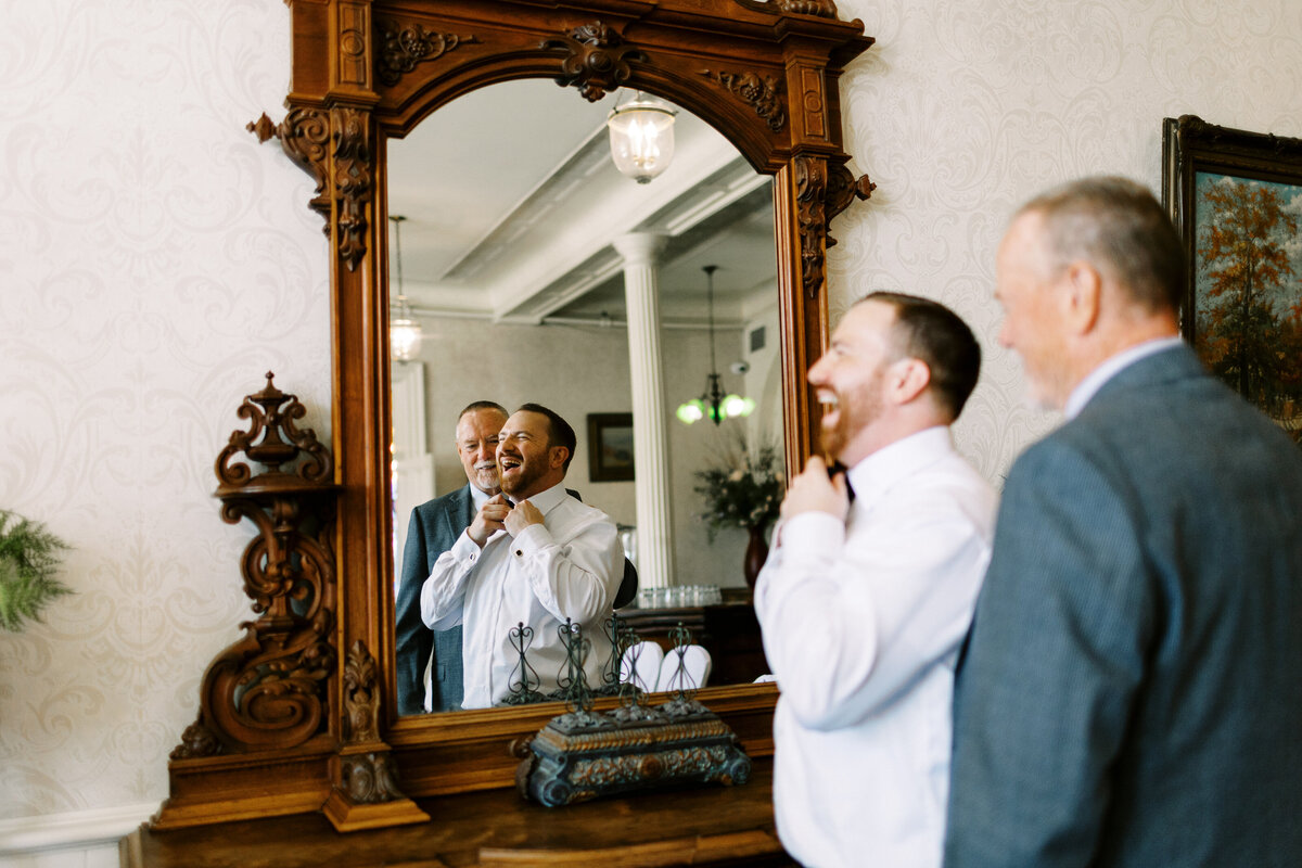 groom getting ready by the mirror