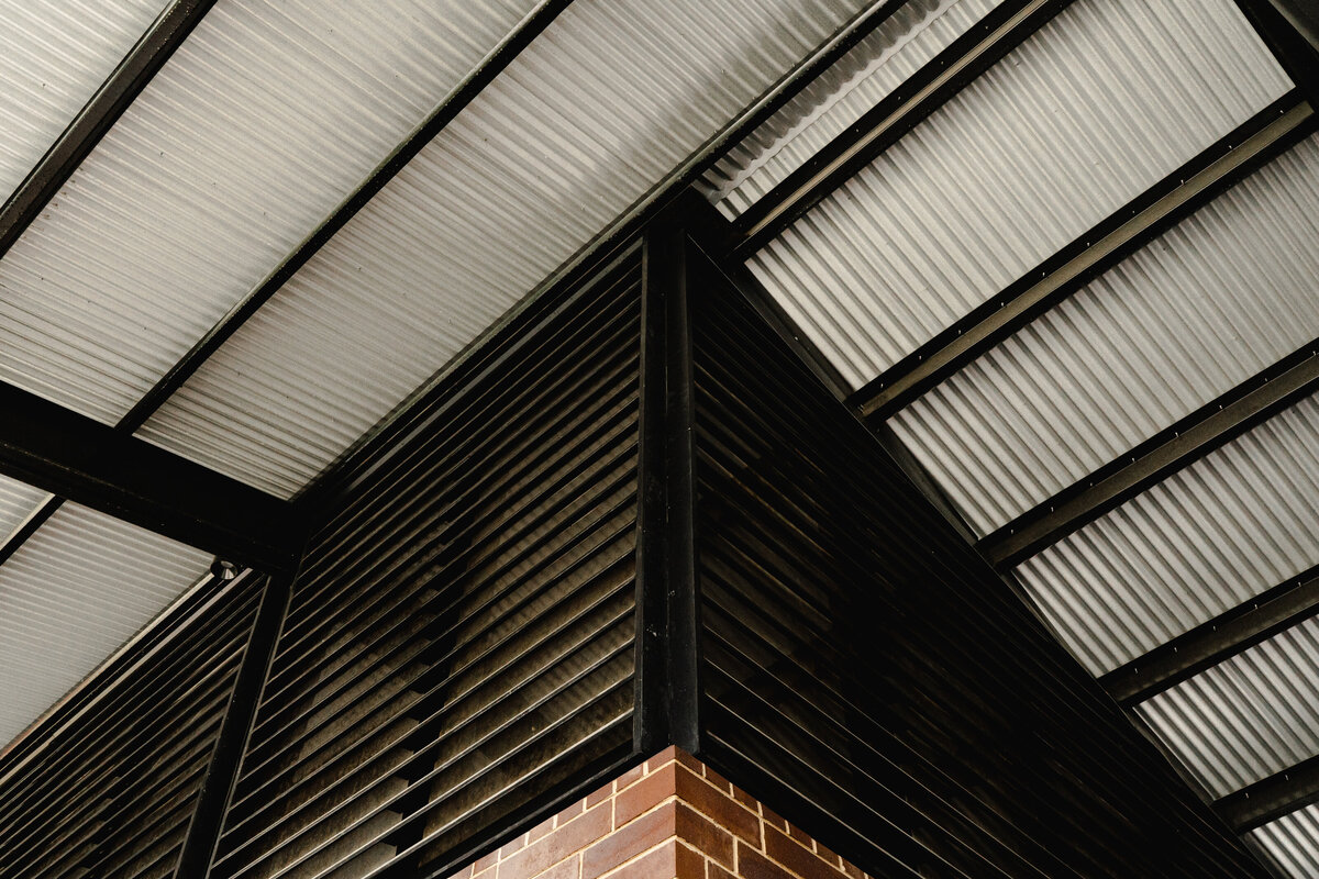 detail of shade structure meeting buliding