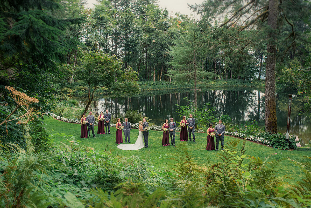 wide view of bridal party and lake