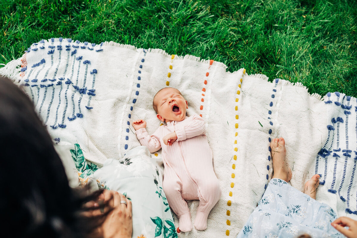 yawning-newborn-on-blanket