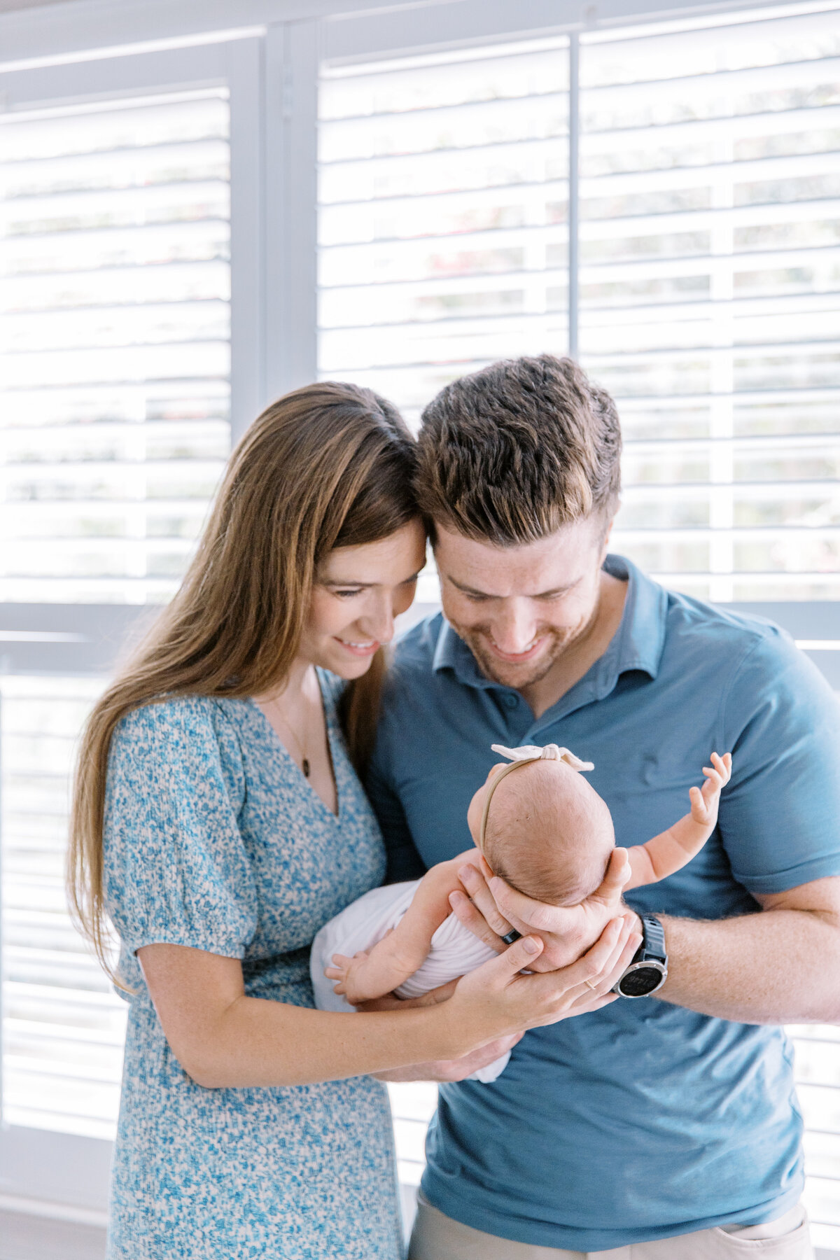 Parents smiling at newborn by Raleigh newborn photographer