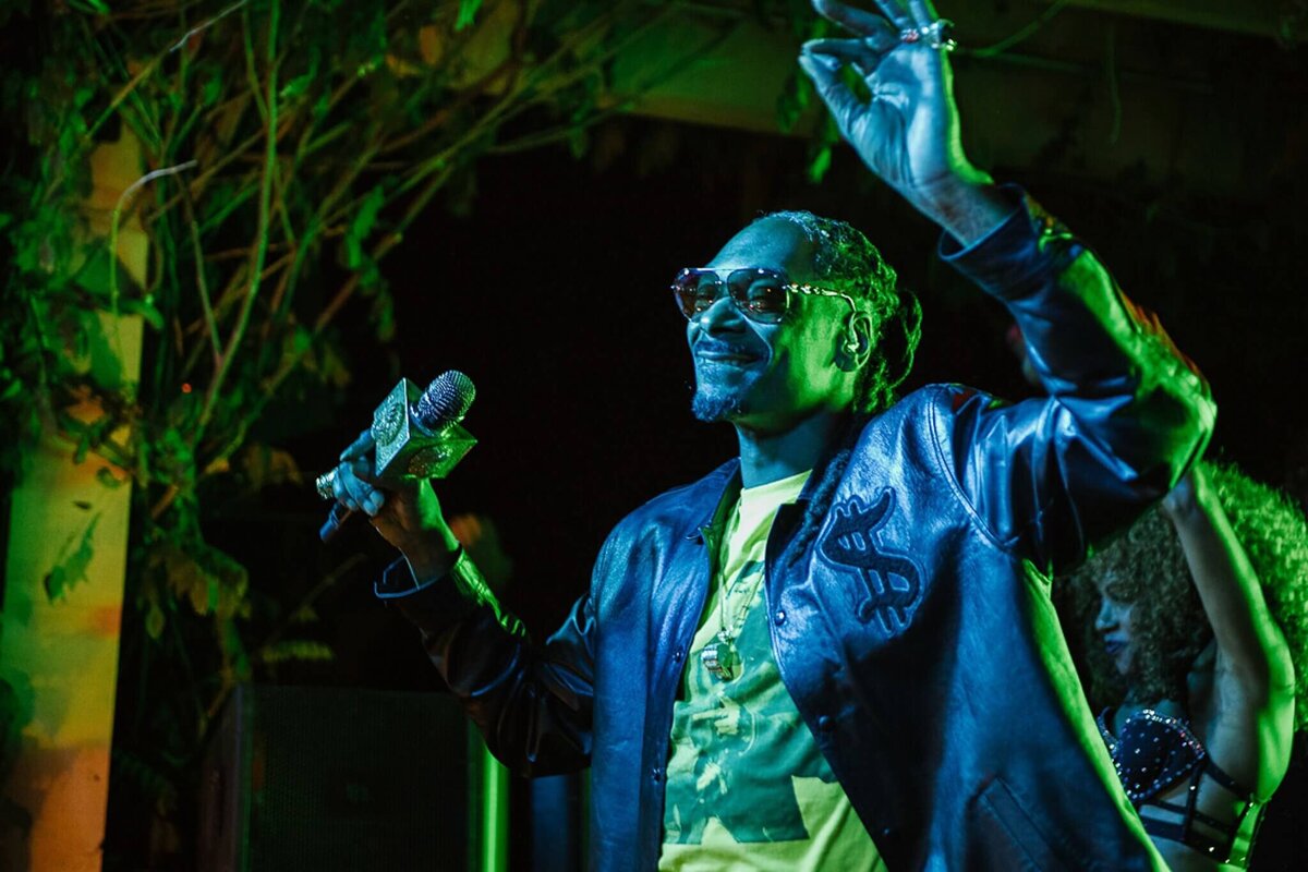 Snoop Dogg performing at a private event under stage lights