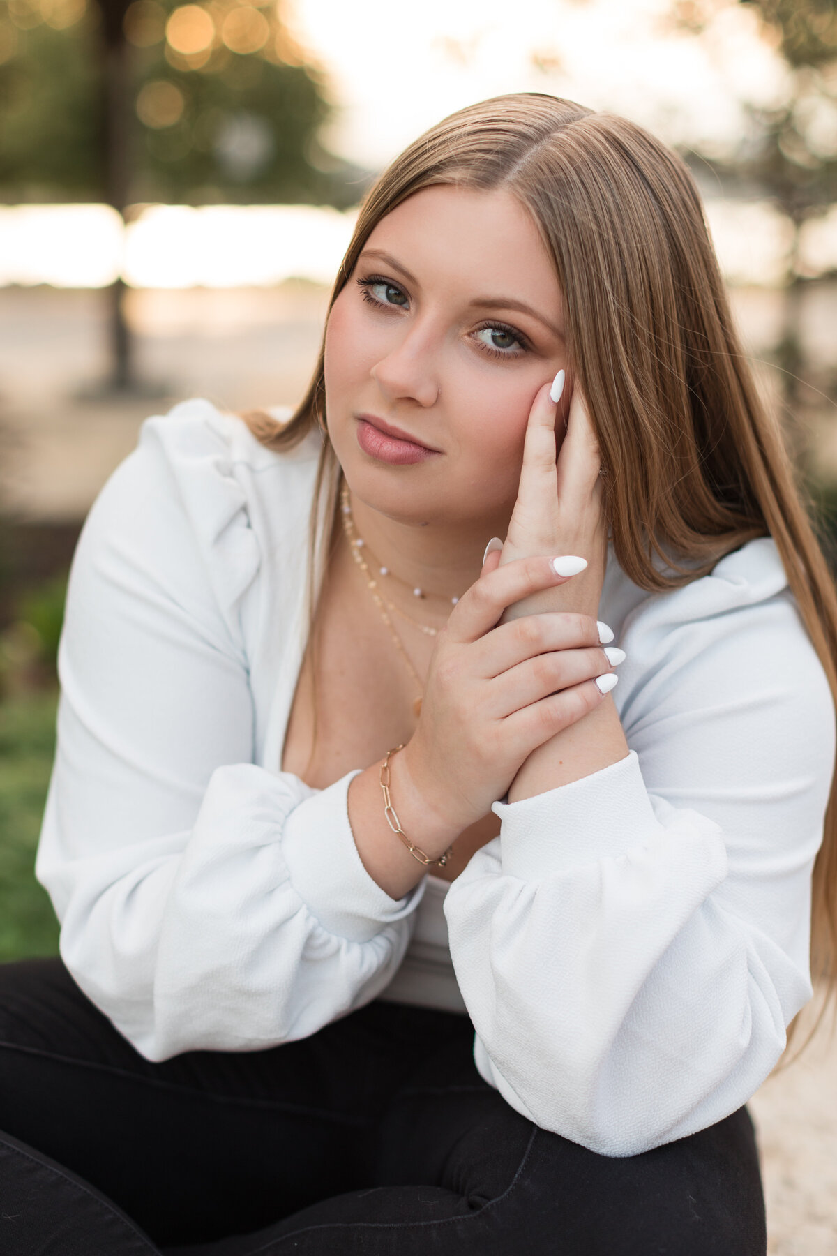Senior girl seated and smiling at the camera