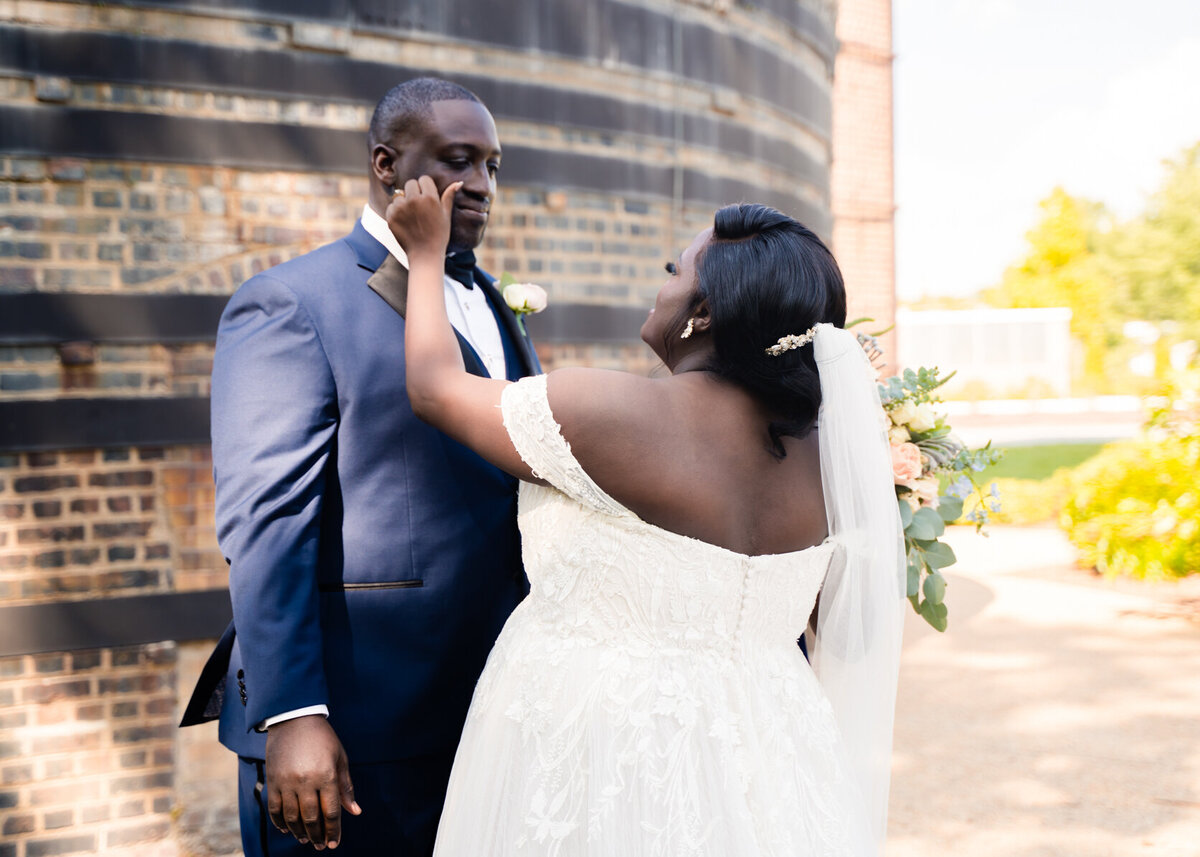 African American bride wipes grooms tears away.