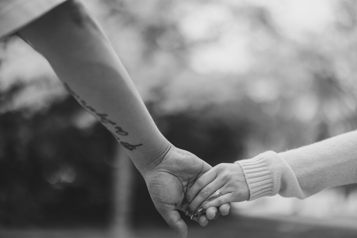 Close up of a couple holding hands.