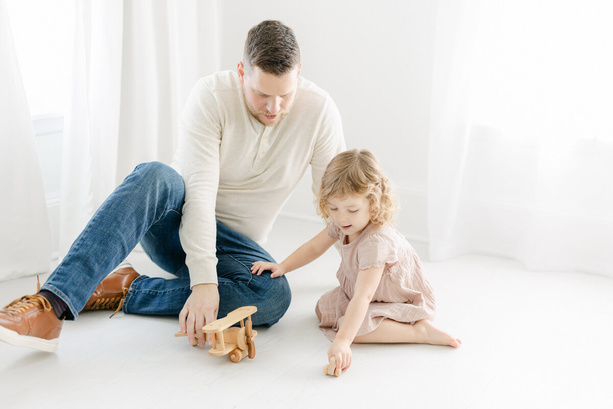 a man playing with his daughter