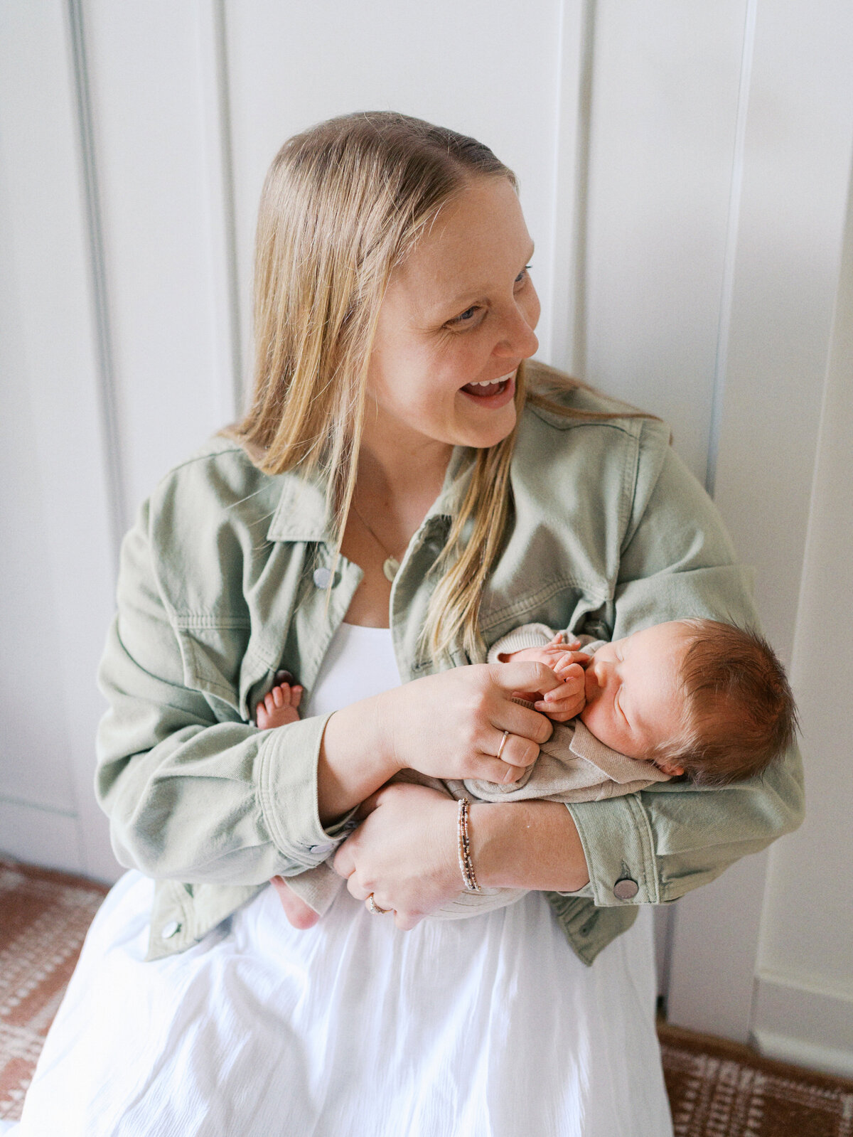 mom-laughing-holding-baby