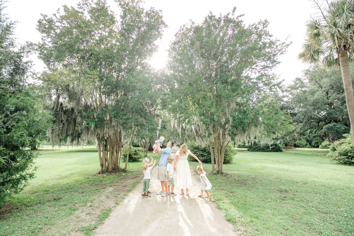Family poses candid for portrait session on the Isle of Palms with Karen Schanely