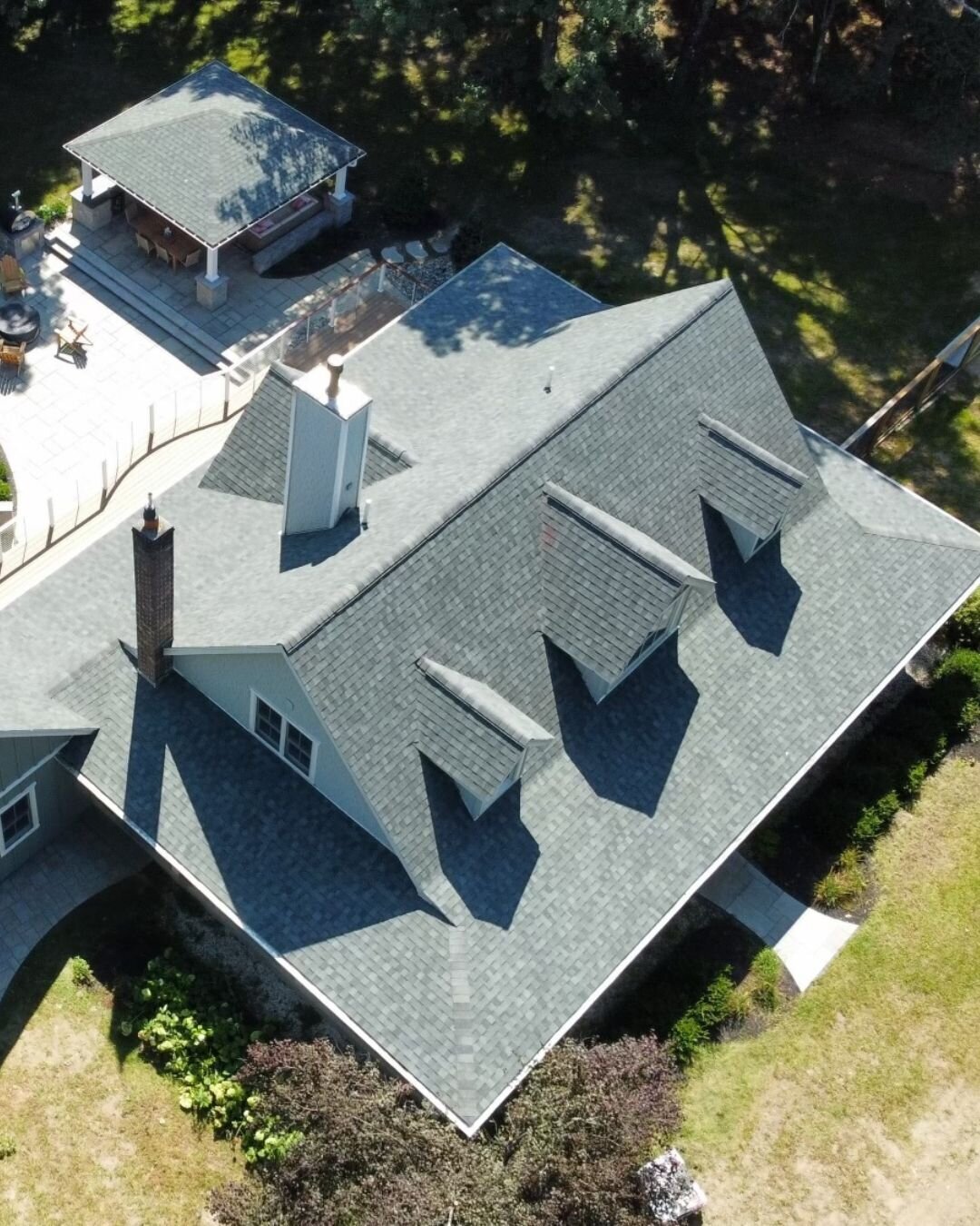 Aerial view of a residential home with newly replaced asphalt shingles