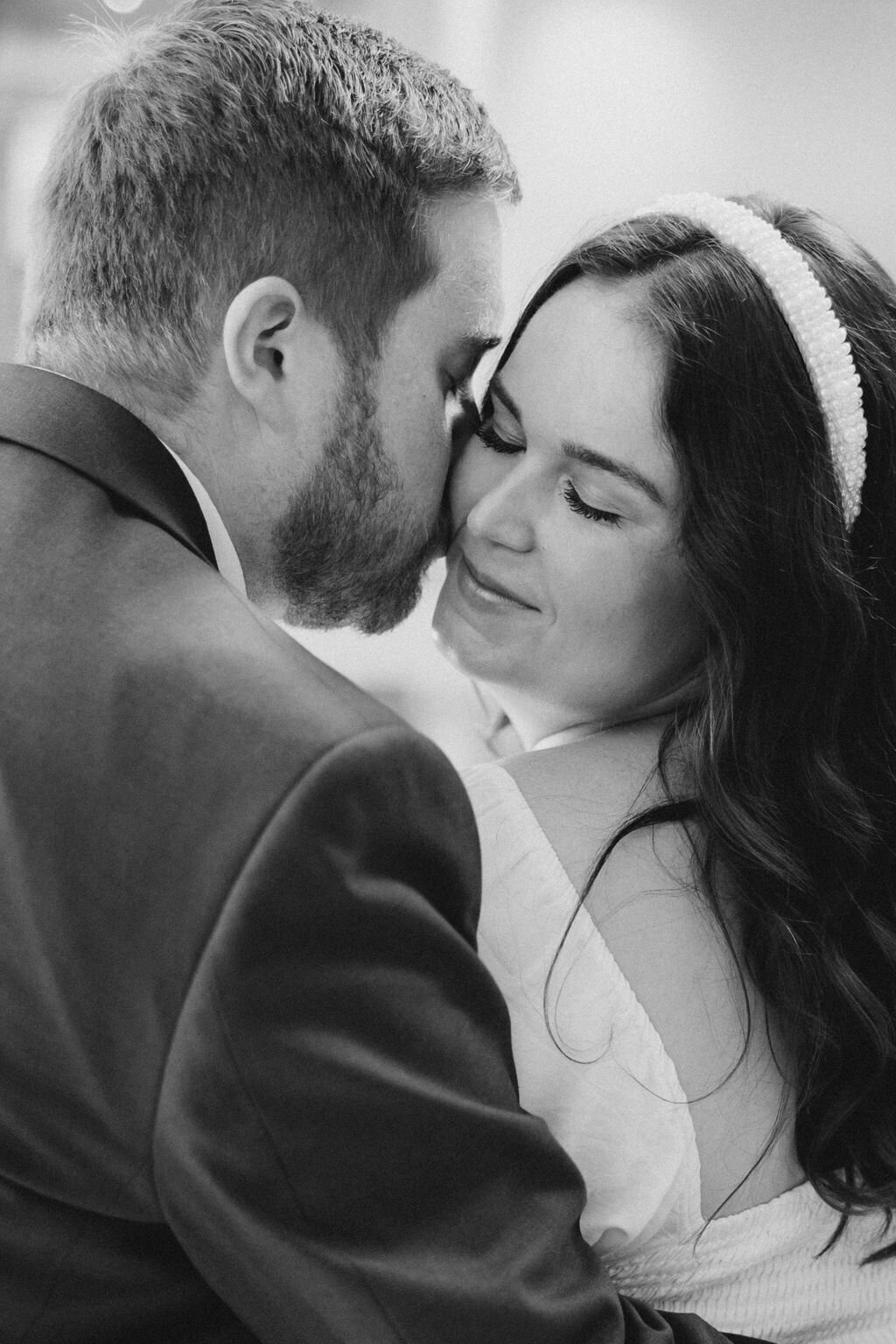 Groom kisses bride on the cheek