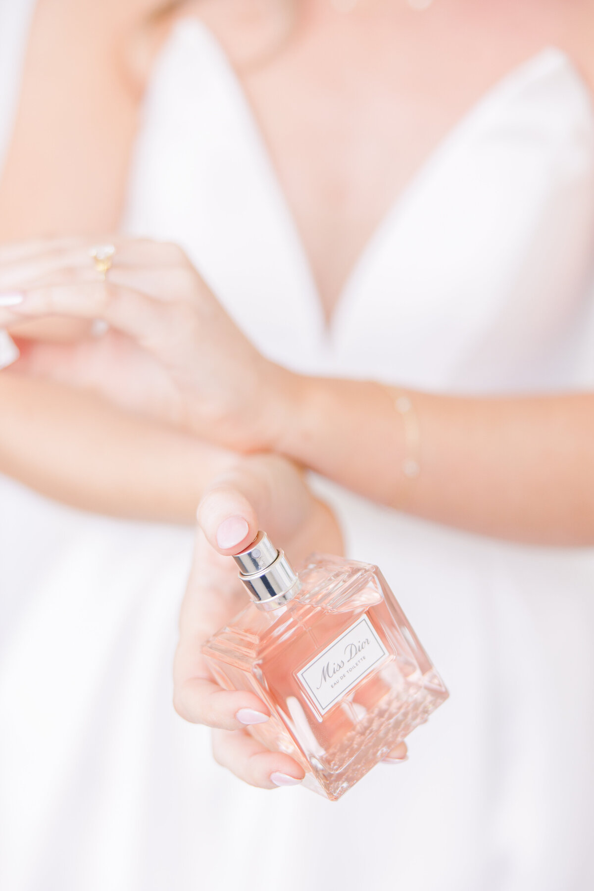 Close up of bride applying perfume representing editorial Boston wedding photography