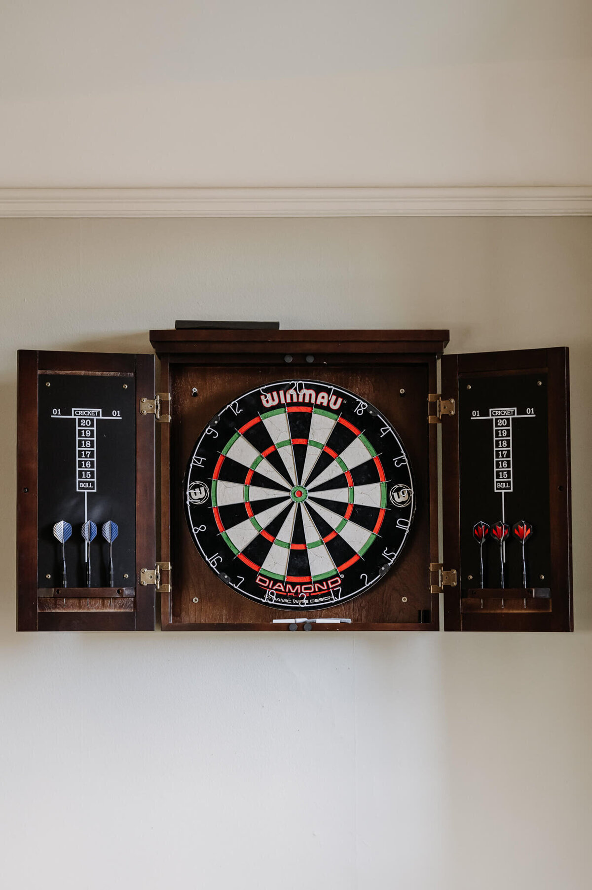 Dart board feature in the relaxed games room at Caswell House