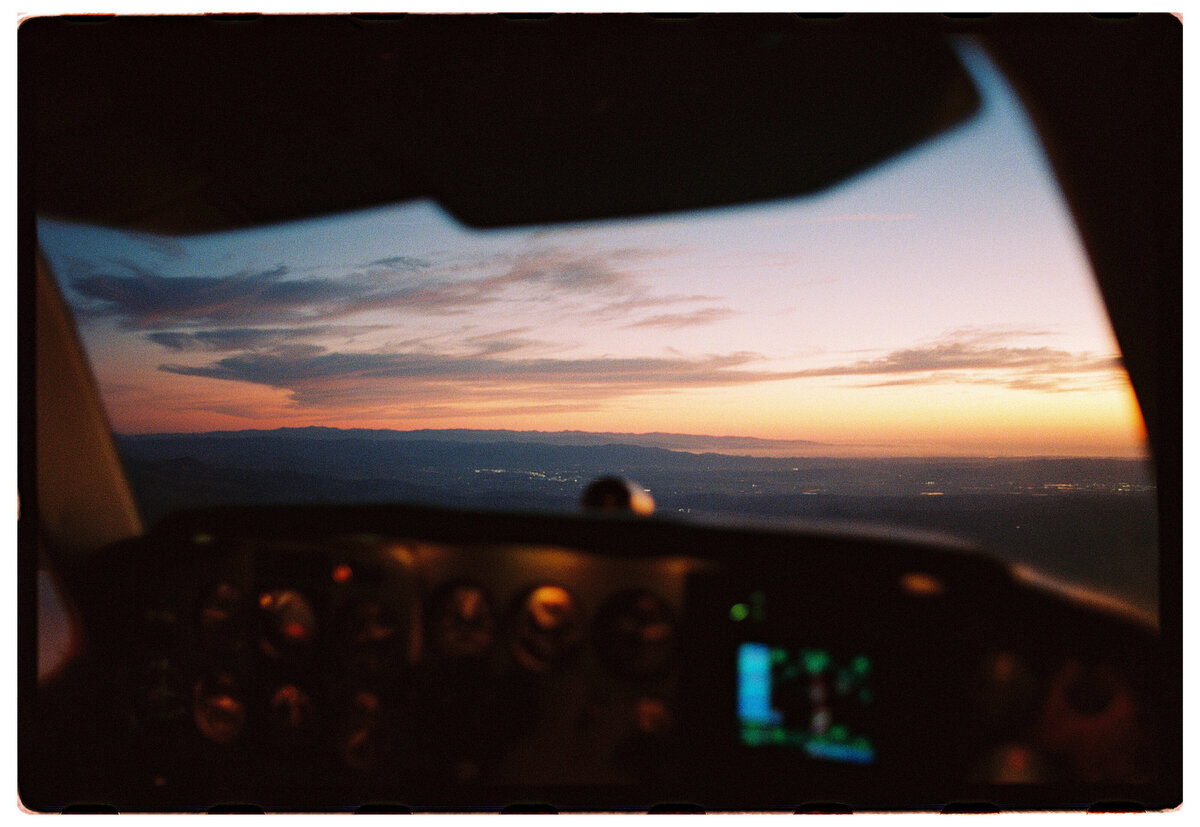 Sunset view from the front of a plane, captured in an authentic style by Kate Winters Photography, Carmel, CA.