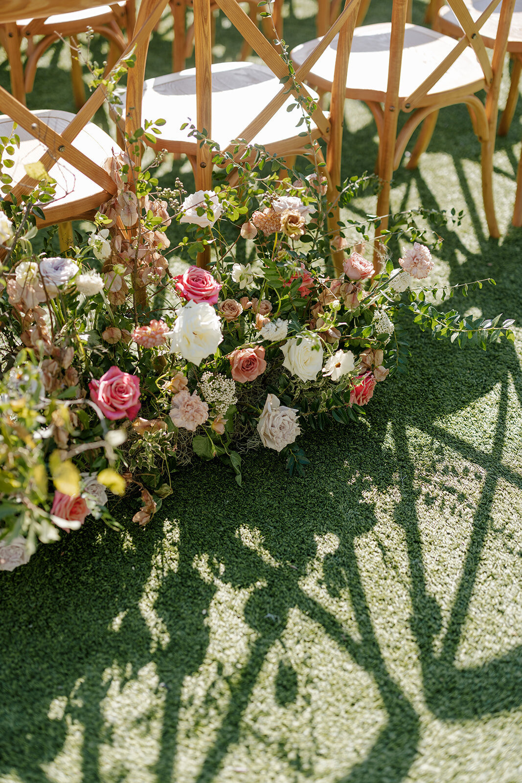 Aisle floral arrangements for fall Carolina’s wedding ceremony in Raleigh. Floral colors in mauve, cream, dusty pink, dusty blue, copper, and natural green. Floral accents of roses and fall color branches. Design by Rosemary and Finch Floral Design based out of Nashville, TN.