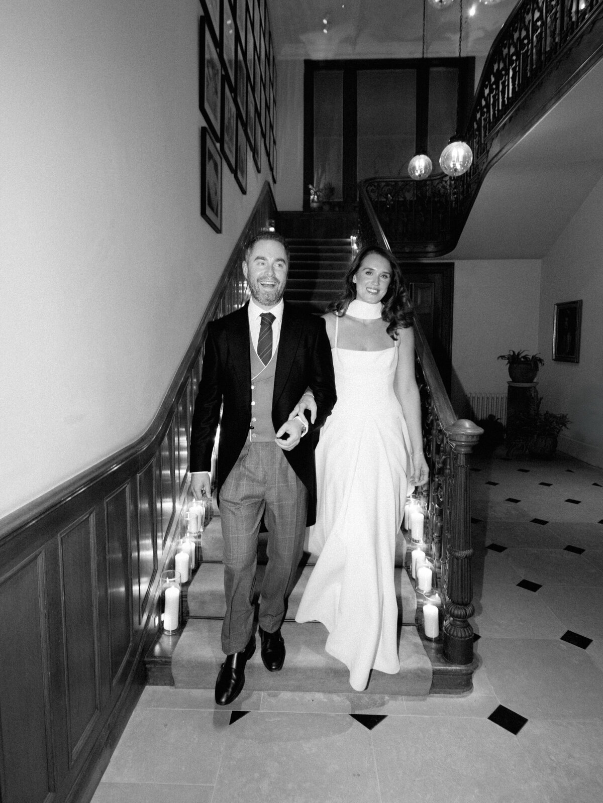 Bride and groom on staircase at Heckfield Place