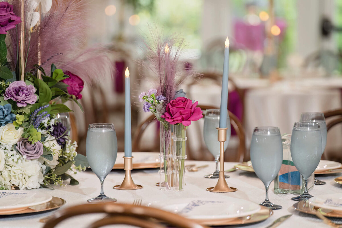 Luxury wedding reception table featuring candlelit ambiance and lush floral arrangements.