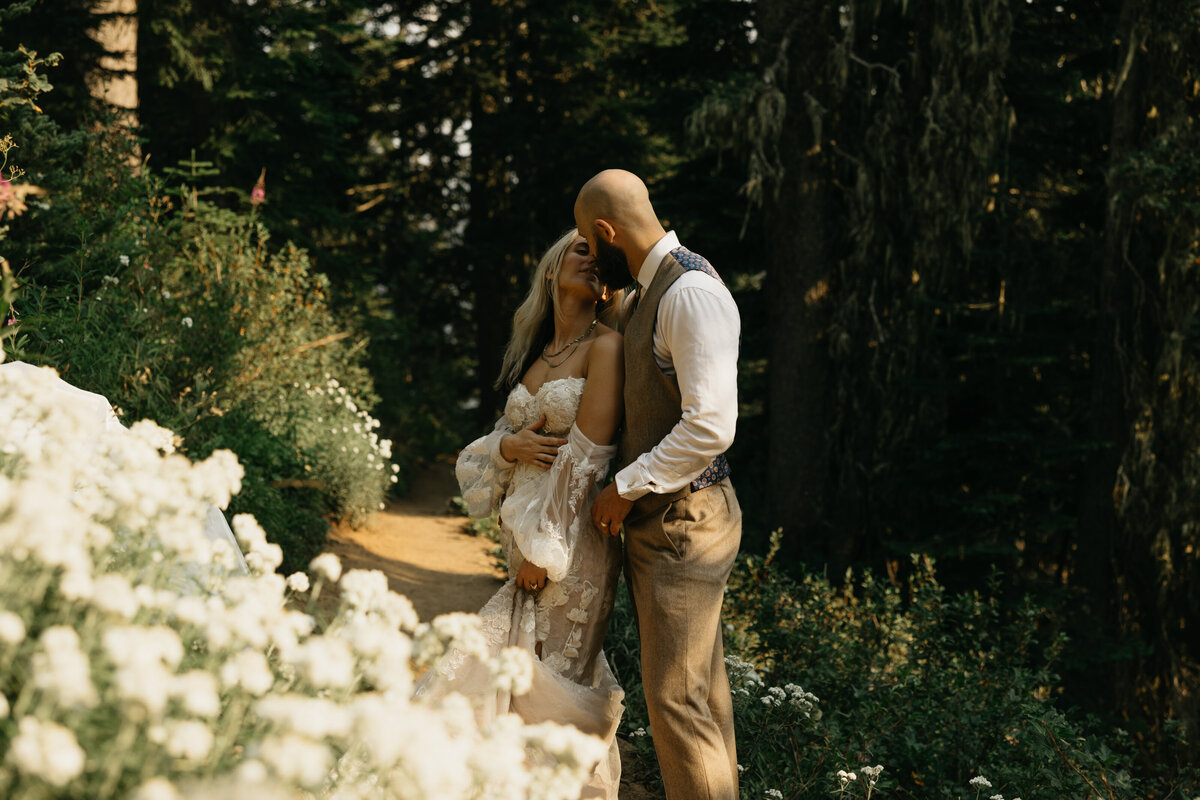 bride and groom embracing in garden