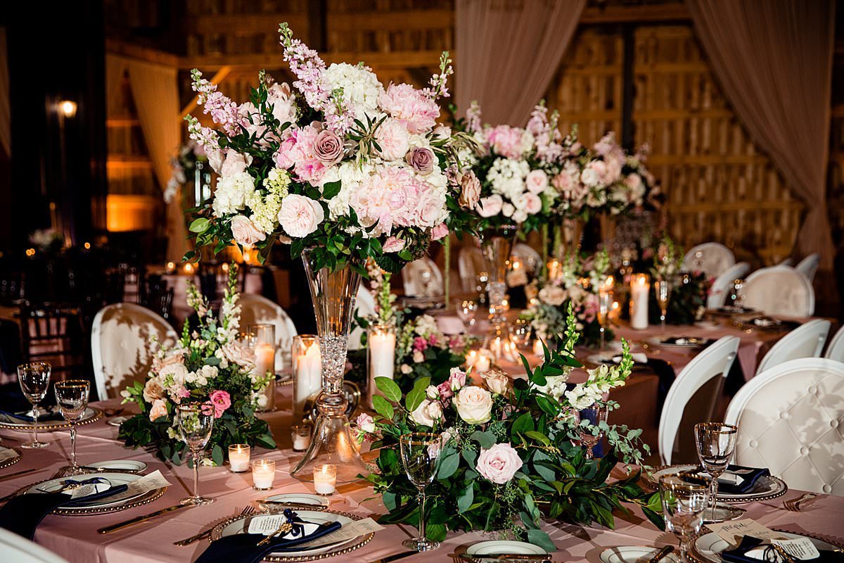 Flower centerpieces for wedding party head table of low and tall centerpieces