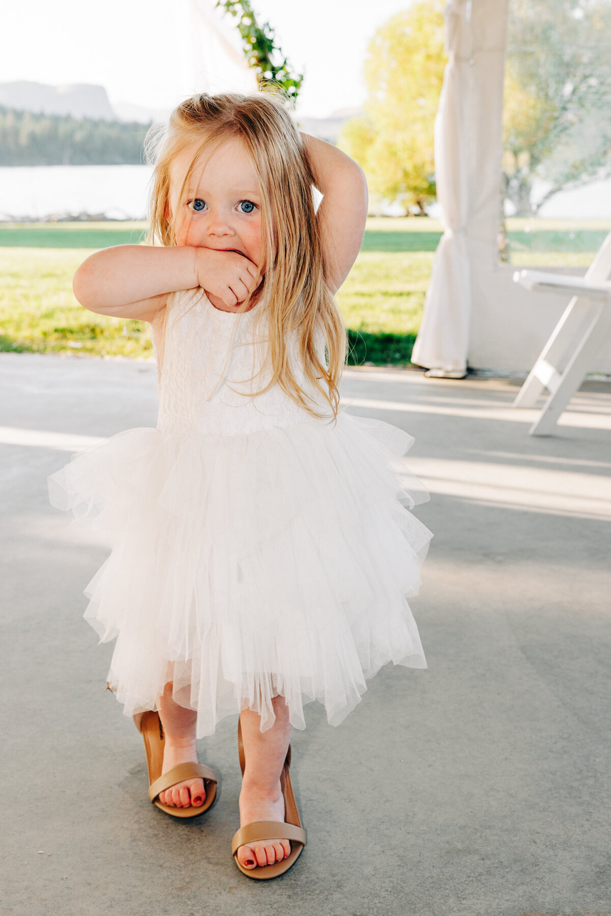 Flower girl wearing her mom's shoes at Flathead Lake Forevers in Big Arm, MT