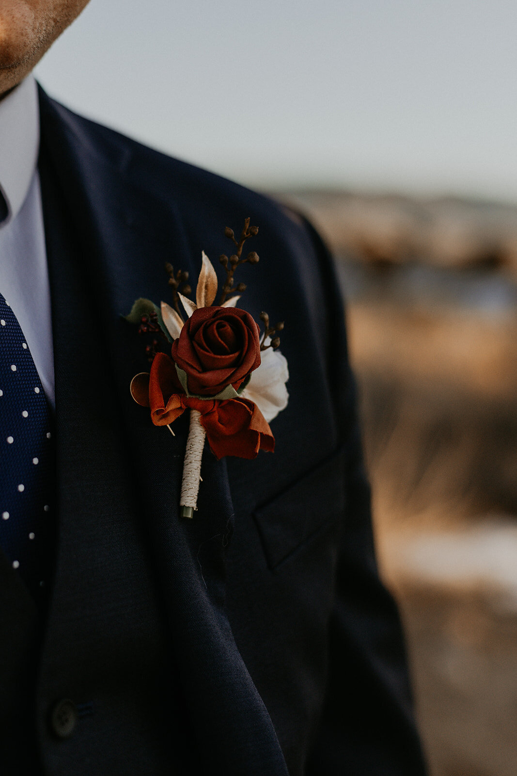 close up of groom jacket details