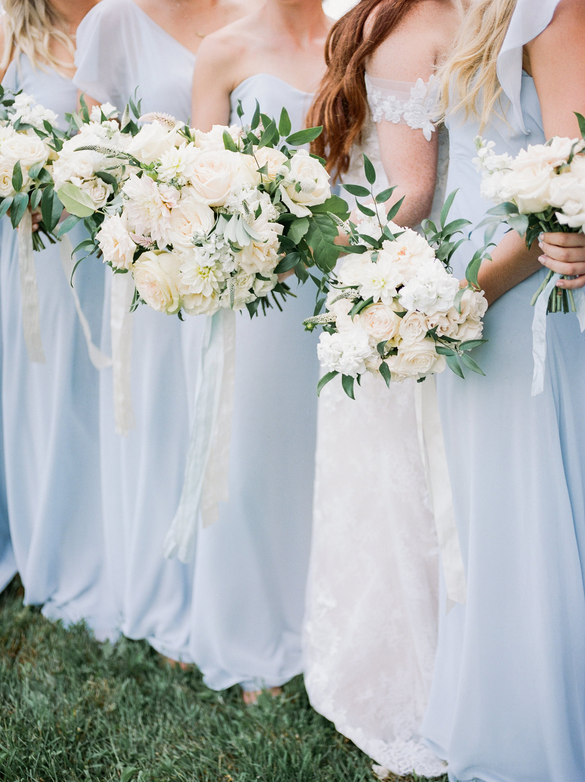 bride with bridesmaids wearing powder blue dresses