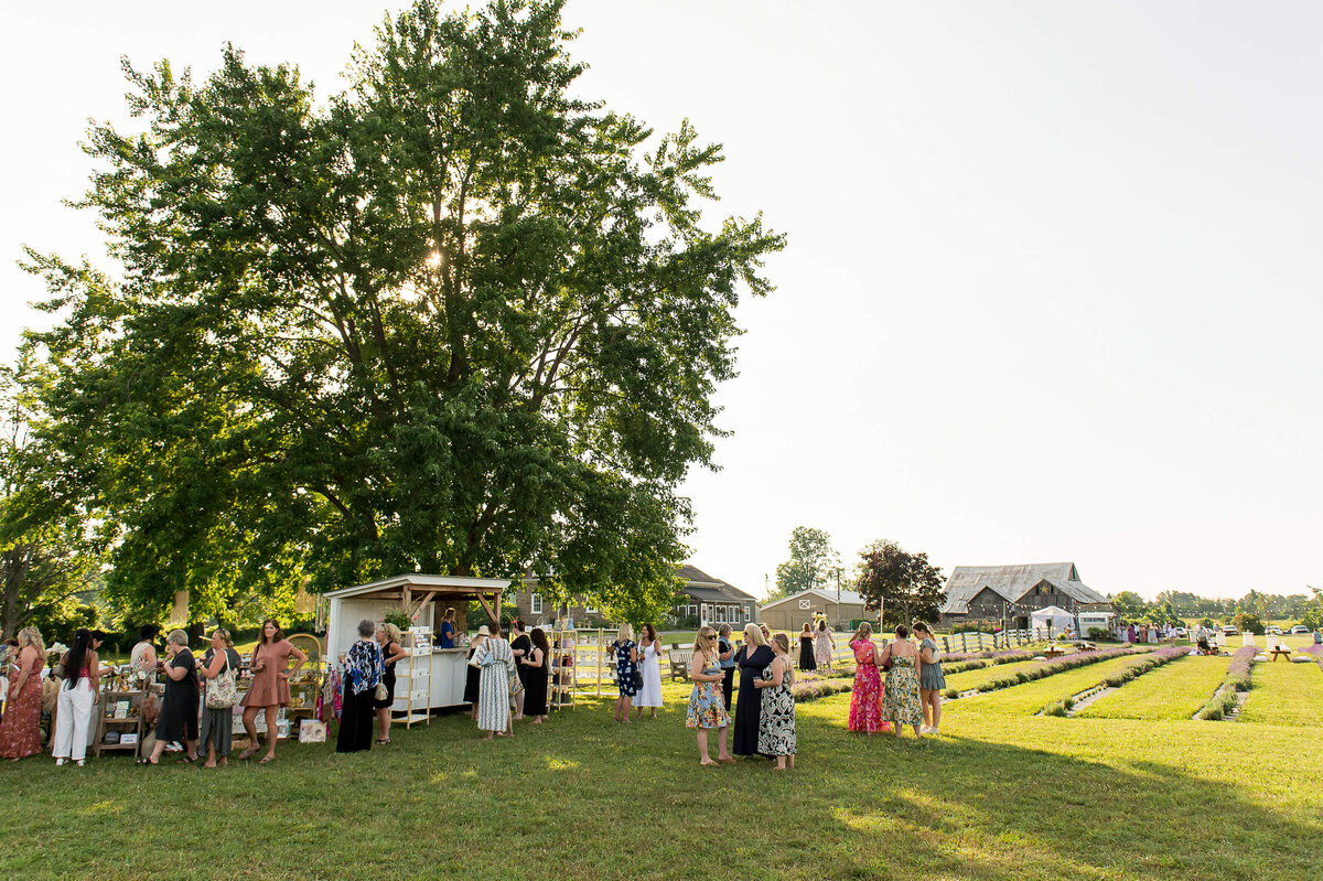 Ottawa event photos of a wide angle photo of Soiree in the Field showing the vendors, mobile bar, lavender fields.  Captured by JEMMAN Photography COMMERCIAL