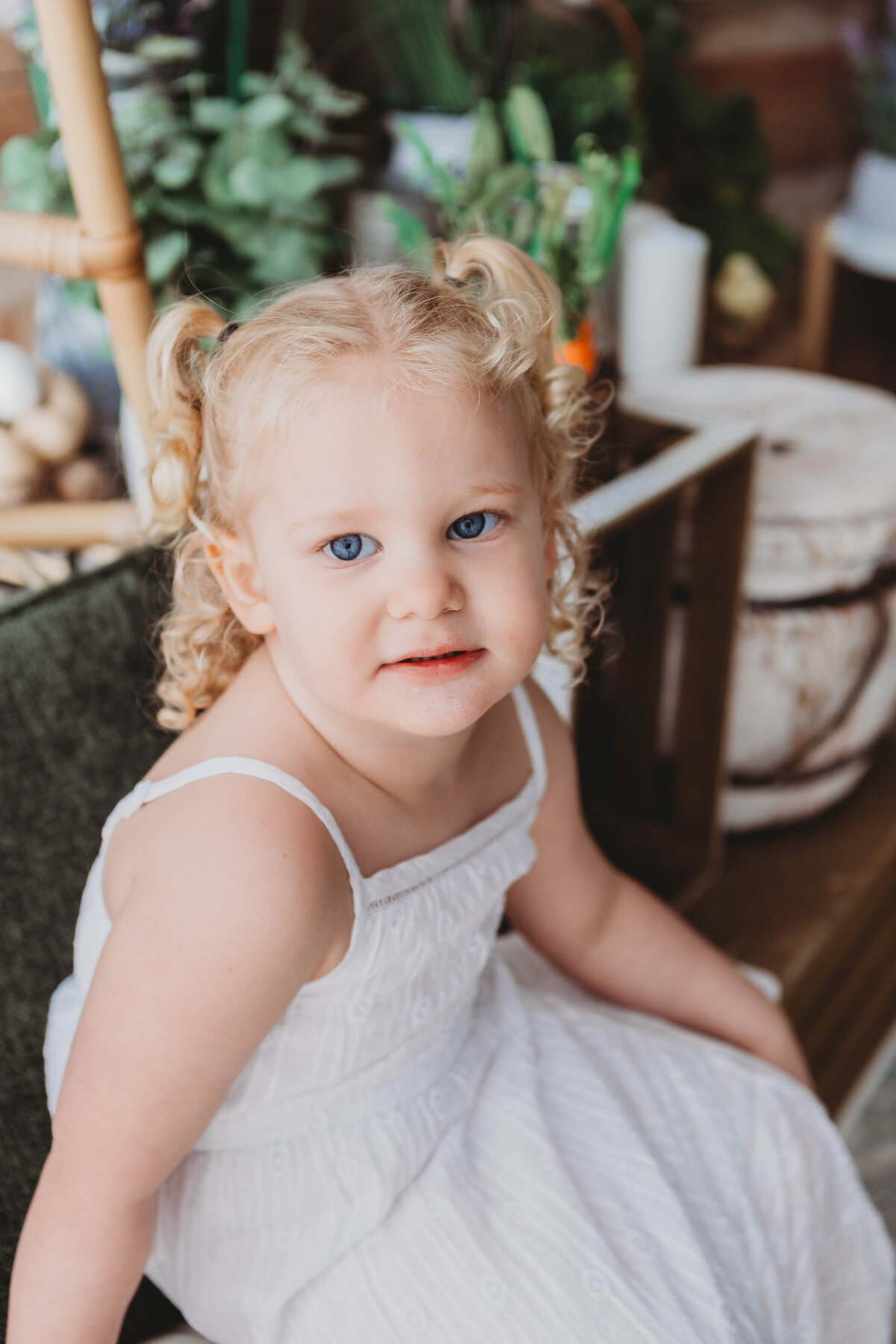 child with blue eyes in white dress