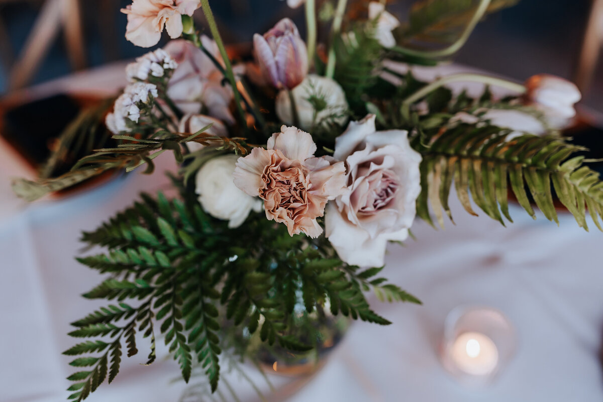 Destination elopement photographer captures wedding table details with flowers