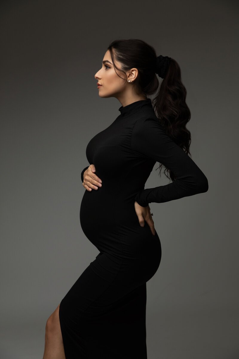 Pregnant mom wearing all black framing her baby bump, by nj maternity photographer
