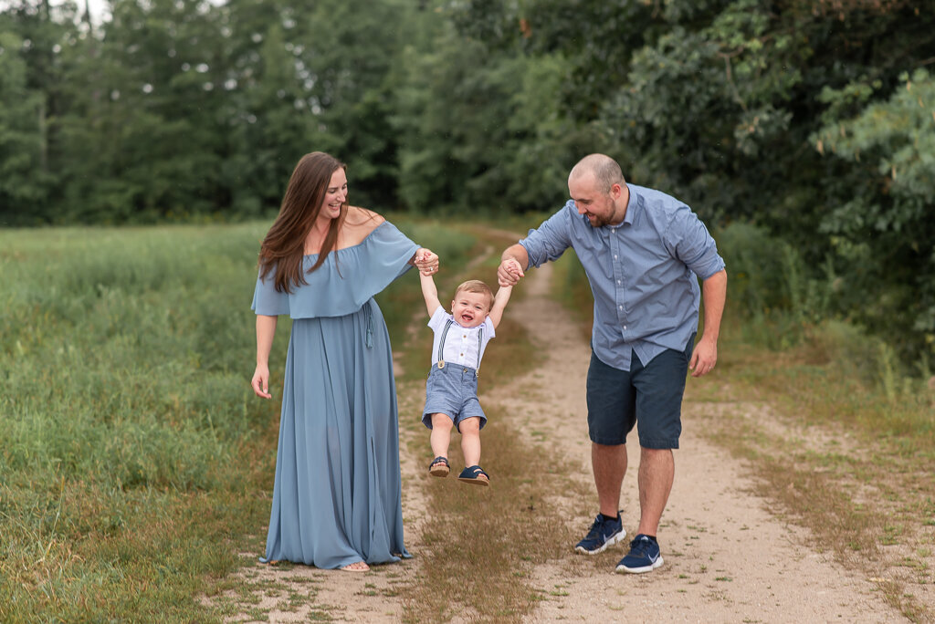 Parents swinging little boy in field at family photo shoot |Sharon Leger Photography, Canton, Connecticut | CT Newborn and Family Photographer