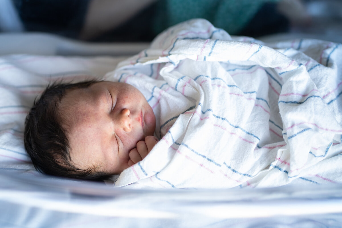 Swaddled baby in hospital room