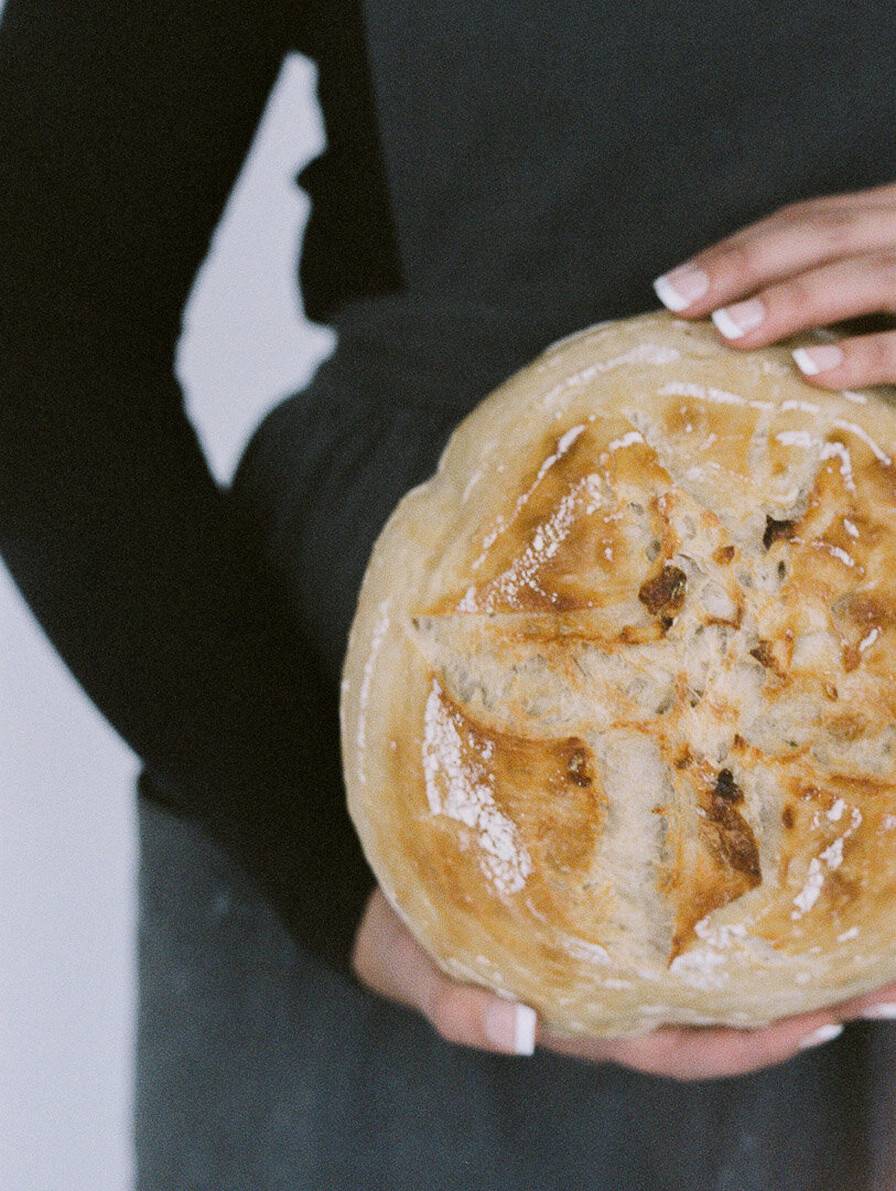baker holding sourdough bread brand session with film