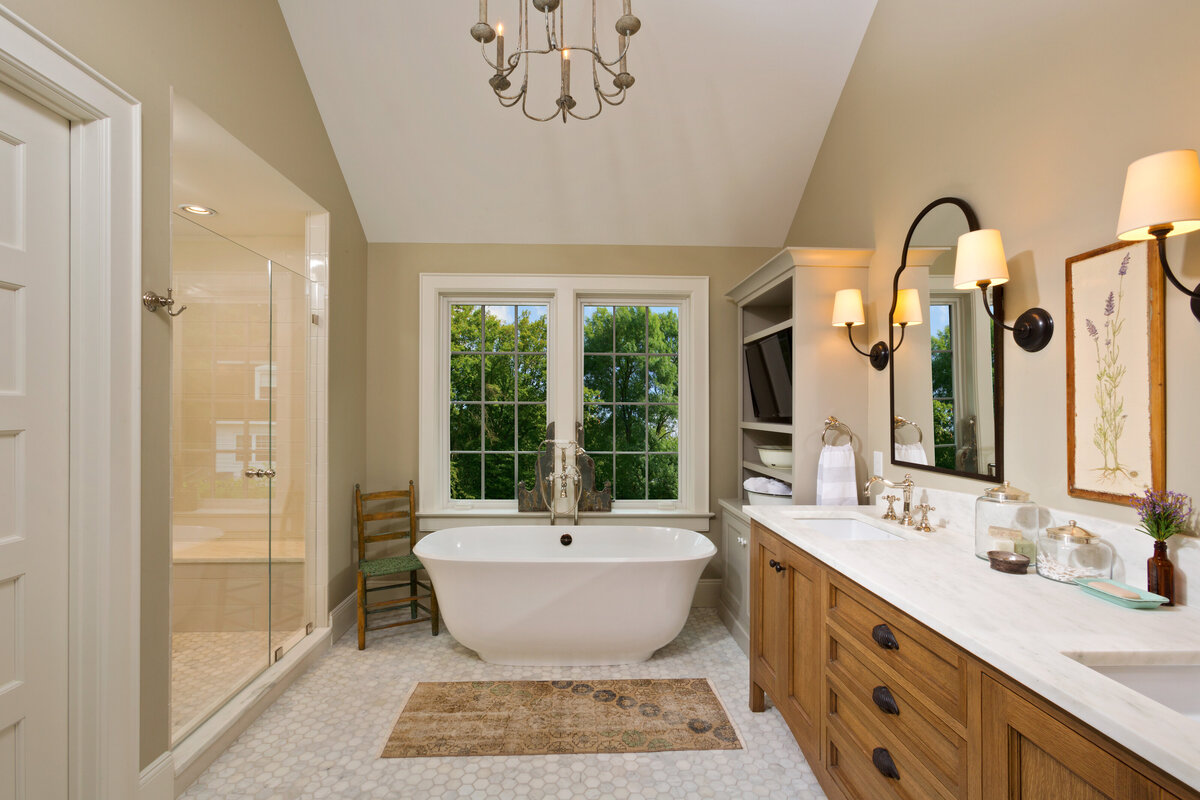 master bath with light wood cabinets are claw foot tub