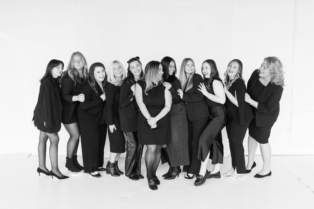 The Aisle & Co. team smiles for a group photo at their headquarters.