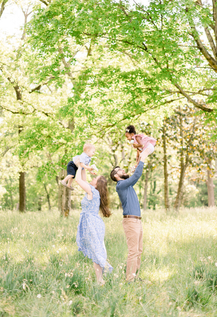 Parents tossing kids in the air