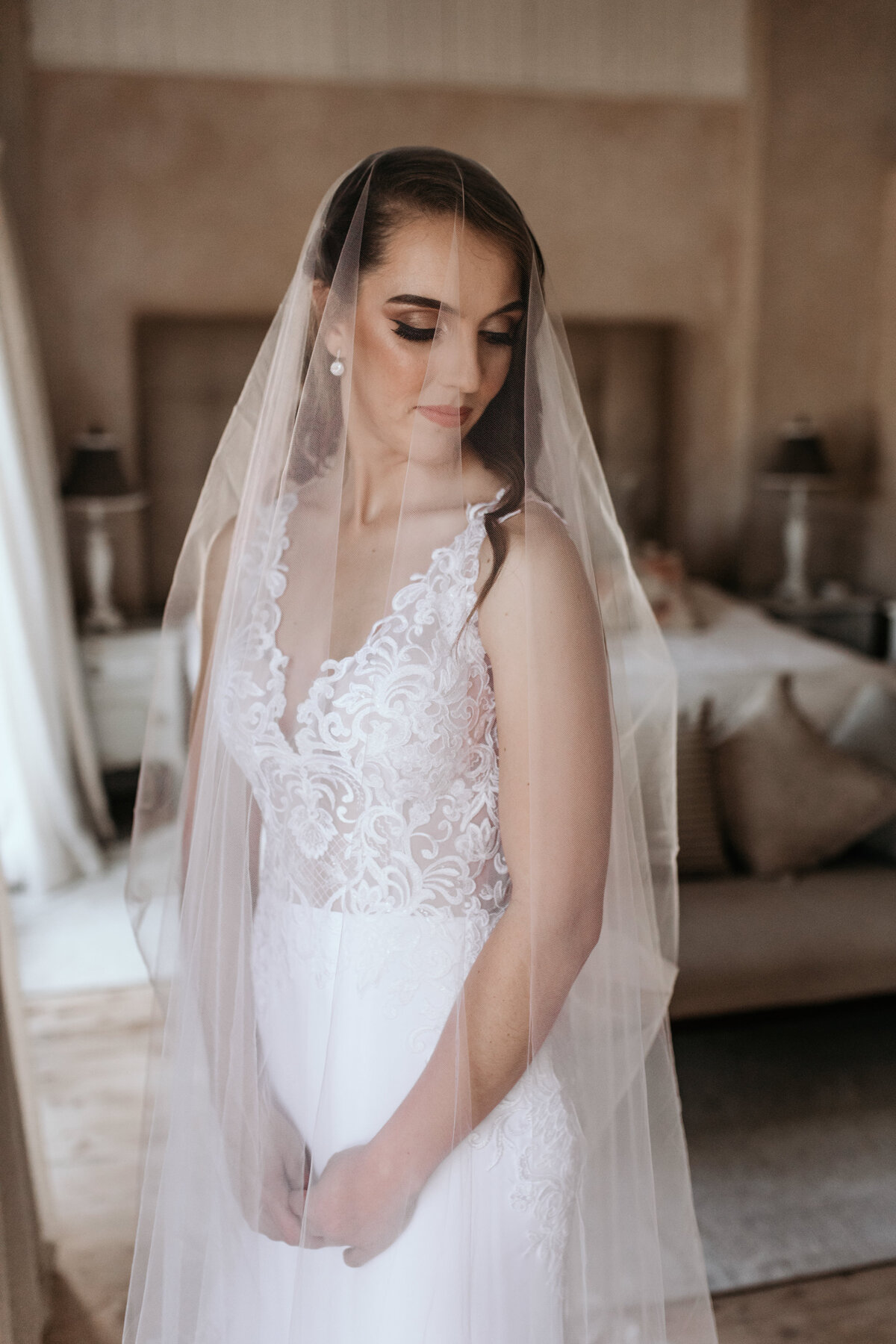 Portrait of Bride draped underneath her veil. 