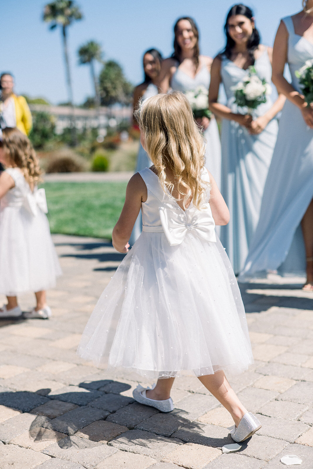 Flower girls walking down the aisle  Dolphin Bay Resort in Pismo Beach, CA