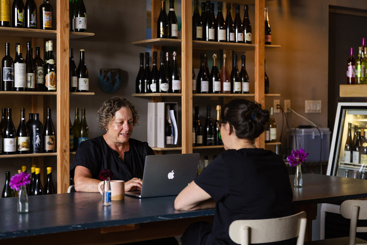 Business Lawyer Cassie Peters works with a client in her Eugene restaurant. 