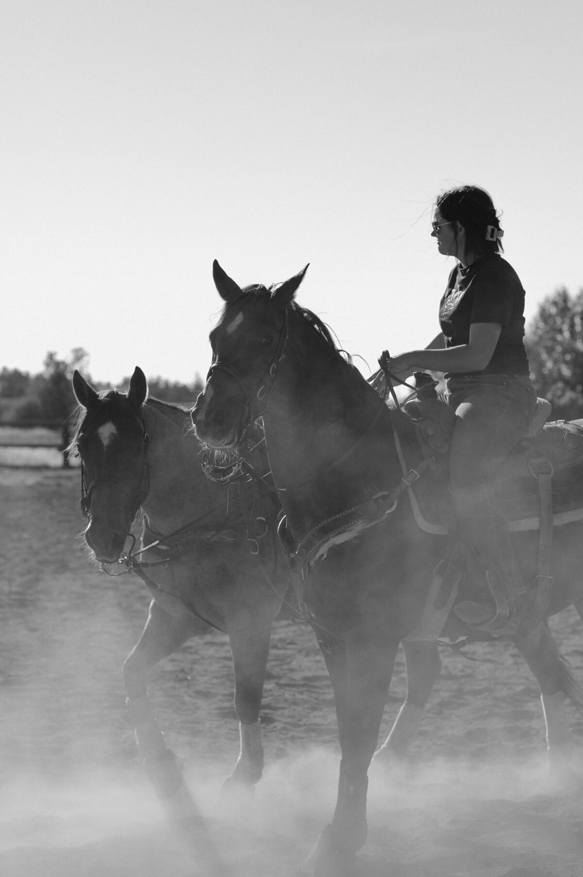 woman riding horses at her ranch in Bend, Oregon