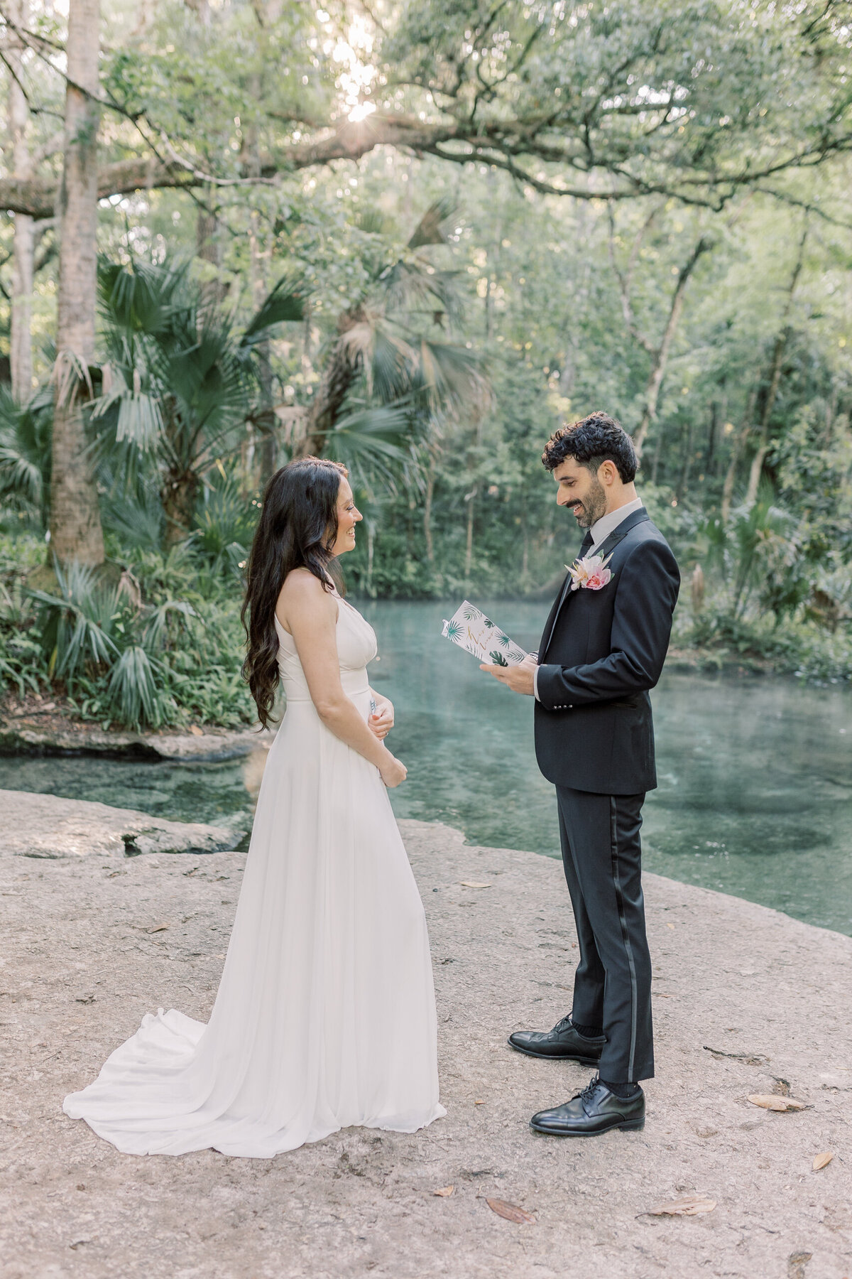 Bride and groom exchanging vows during their private ceremony at Kelly Park by the natural spring in Florida.