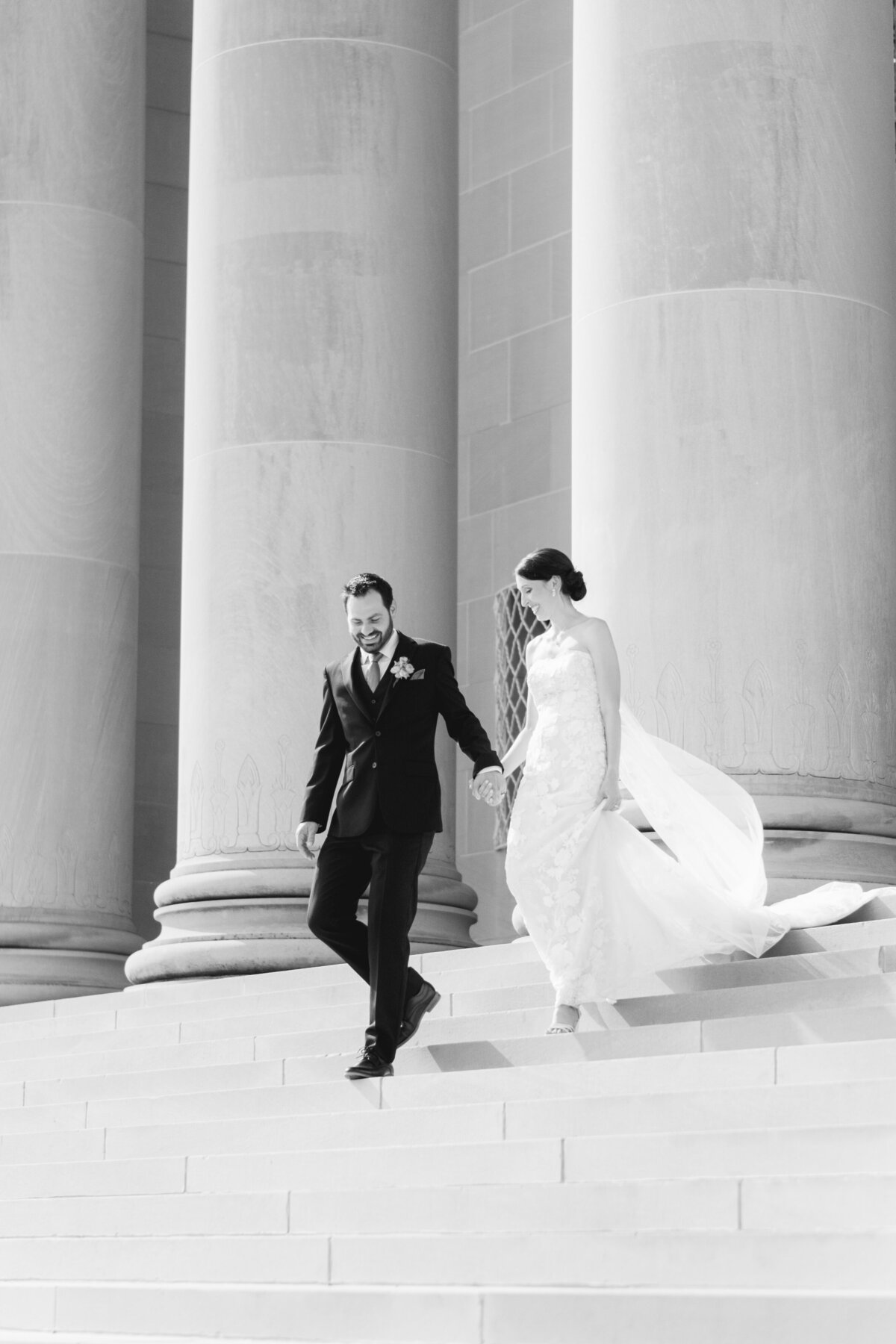black and white image of wedding couple walking down stairs of the Nelson-Atkins Museum