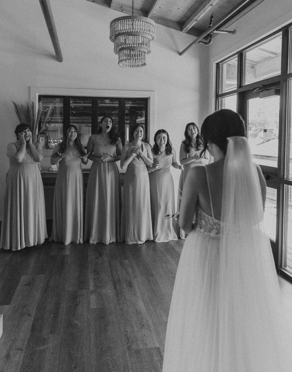 bridesmaids see the bride for the first time with a shocked look