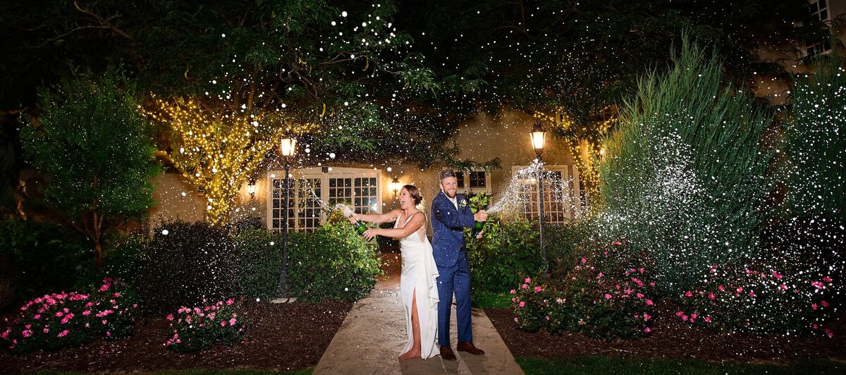 Bride and groom spraying champaign