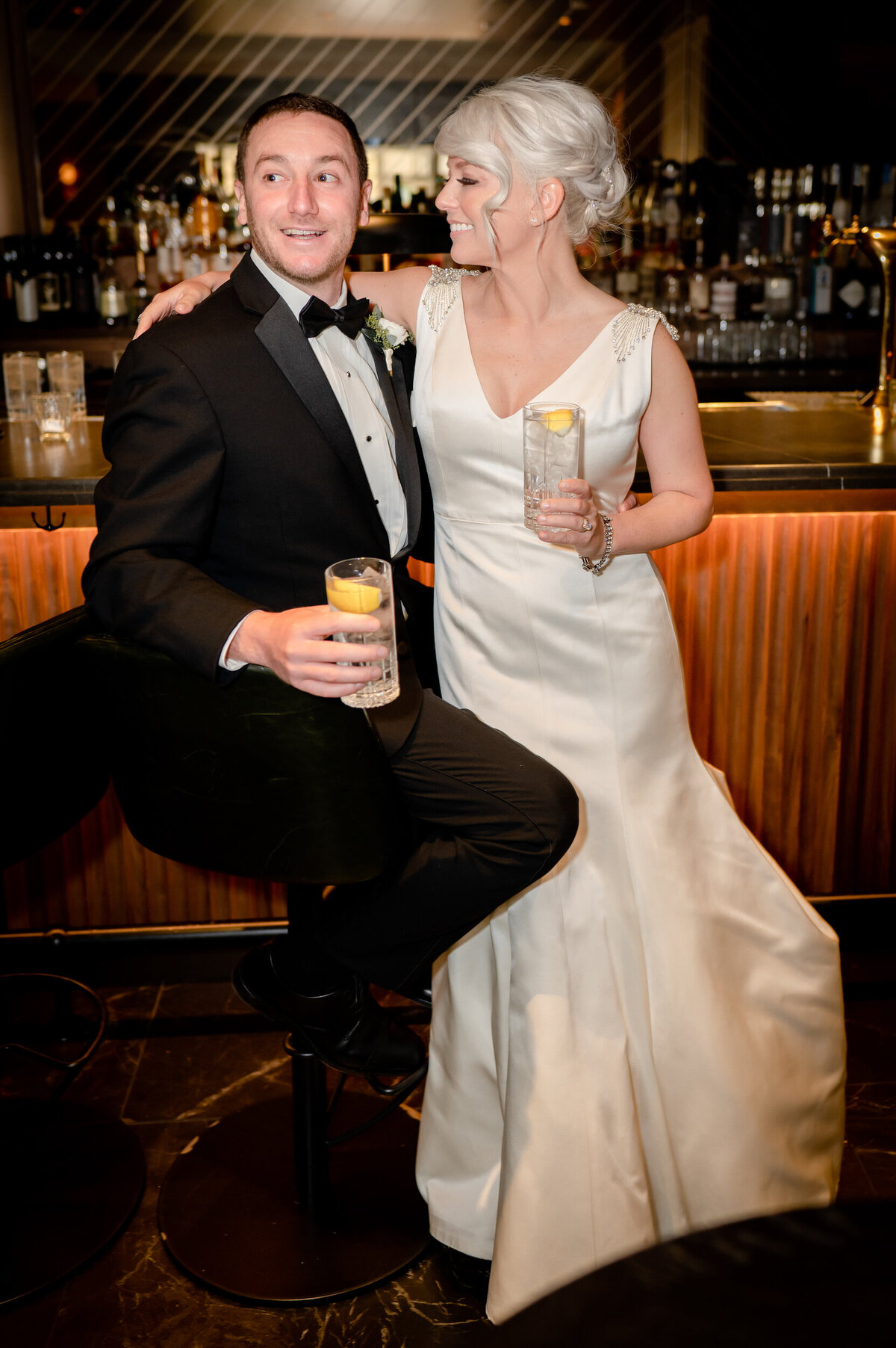 Bride and groom drink a gin and tonic at a Chicago bar during their wedding