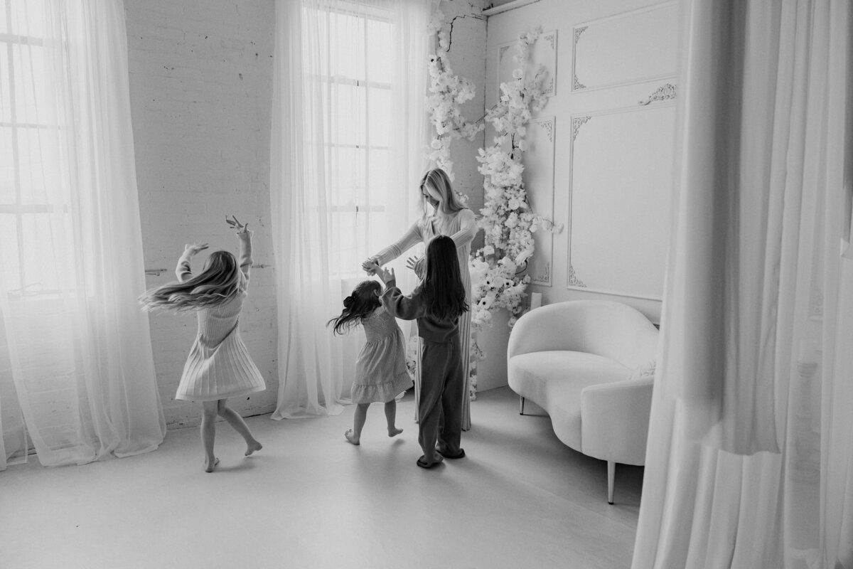 Mom and 3 daughters dancing together