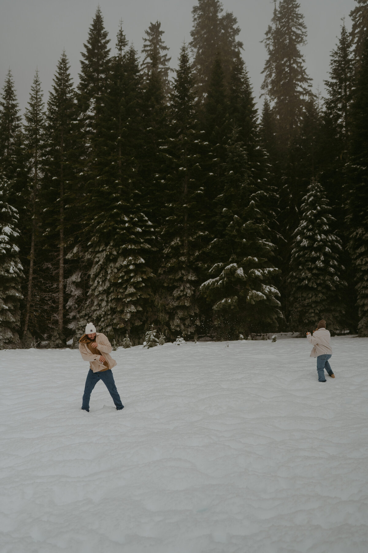 couple having a snow ball fight 