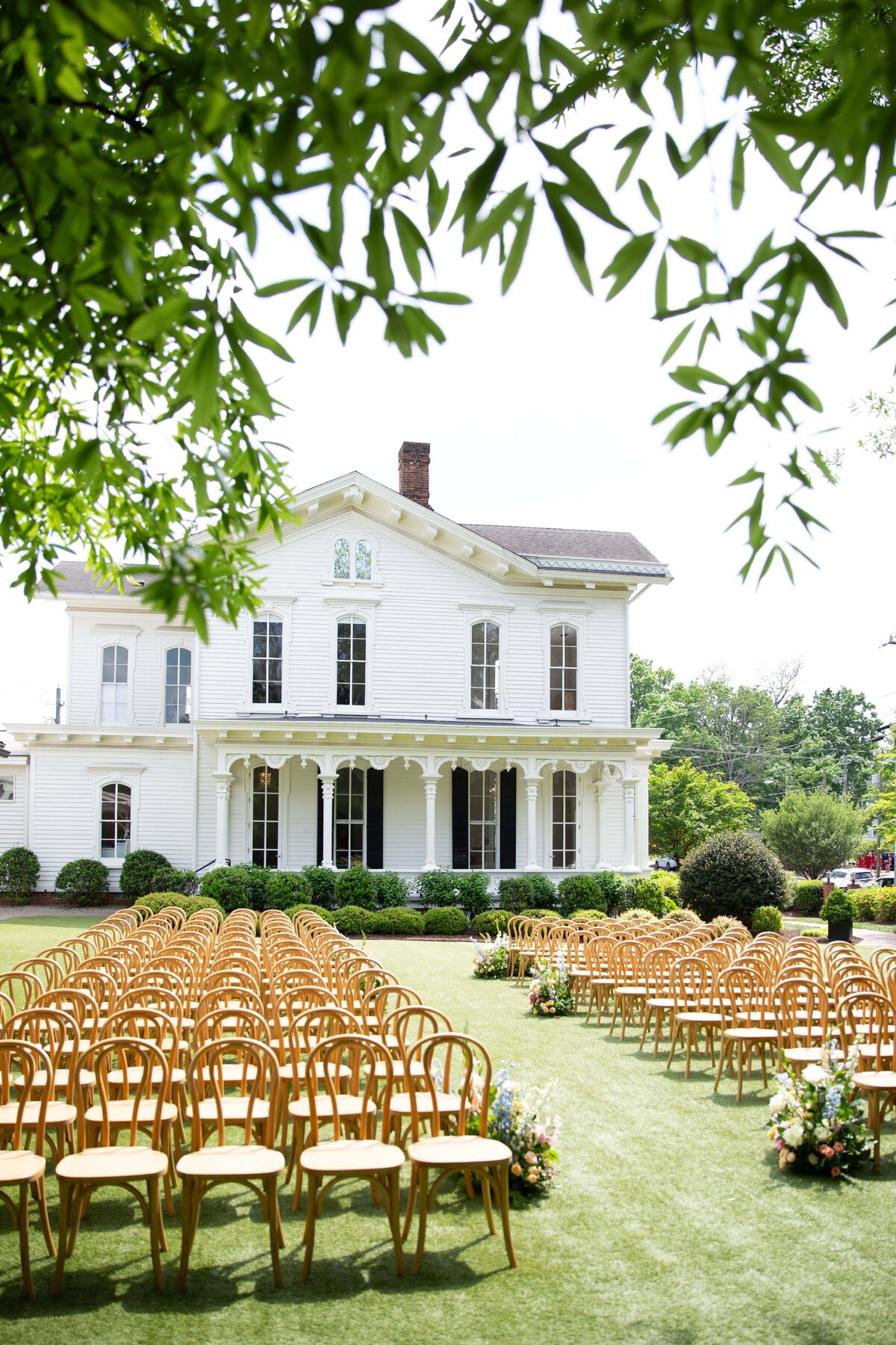 Wedding ceremony setup on the lawn with the Merrimon-Wynne House in the background.
