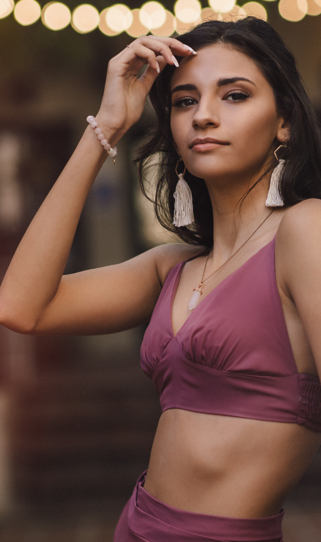 hispanic high school senior in two piece pink outfit